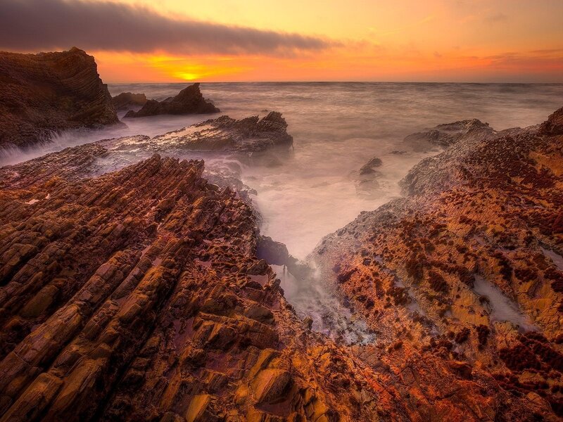 Sunset over rocky coastline