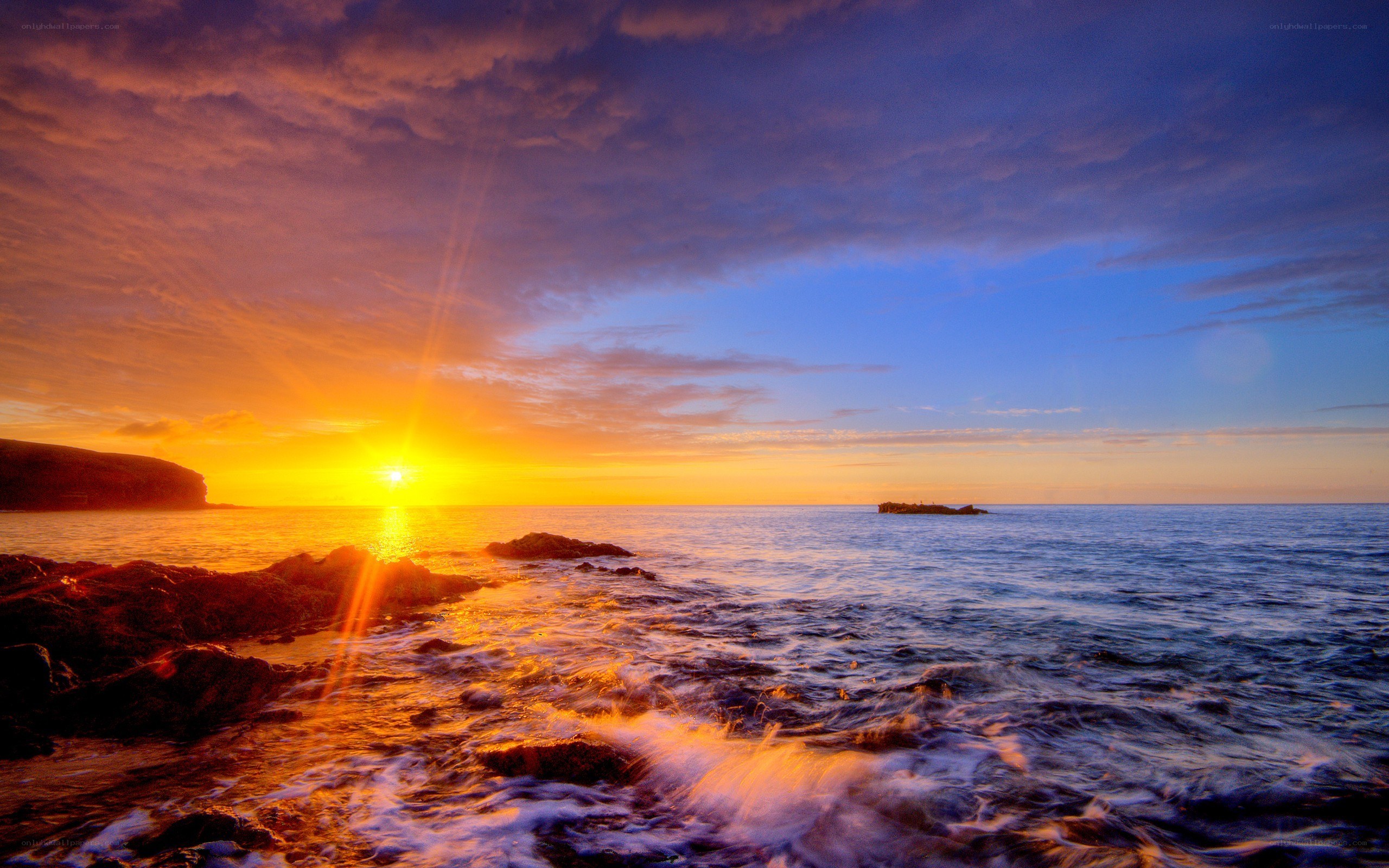 sunset over rocky coastline