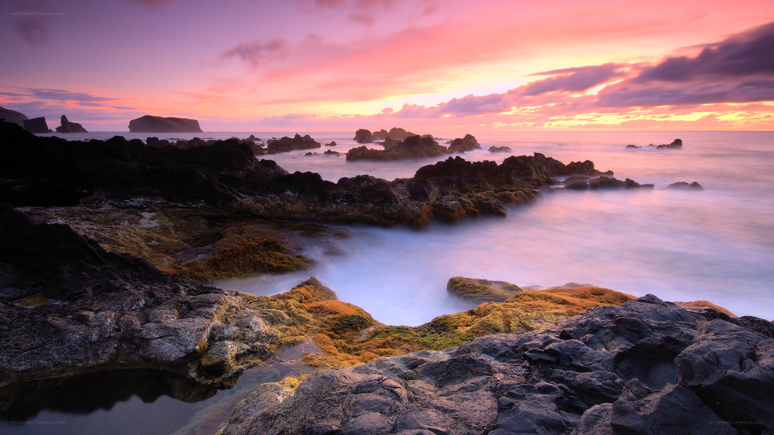 Sunset over rocky coastline