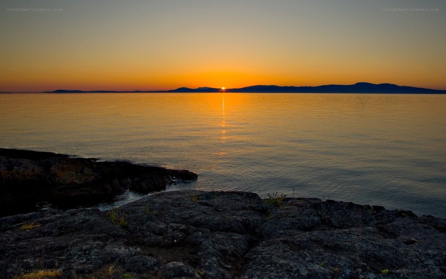 Sunset over rocky coastline