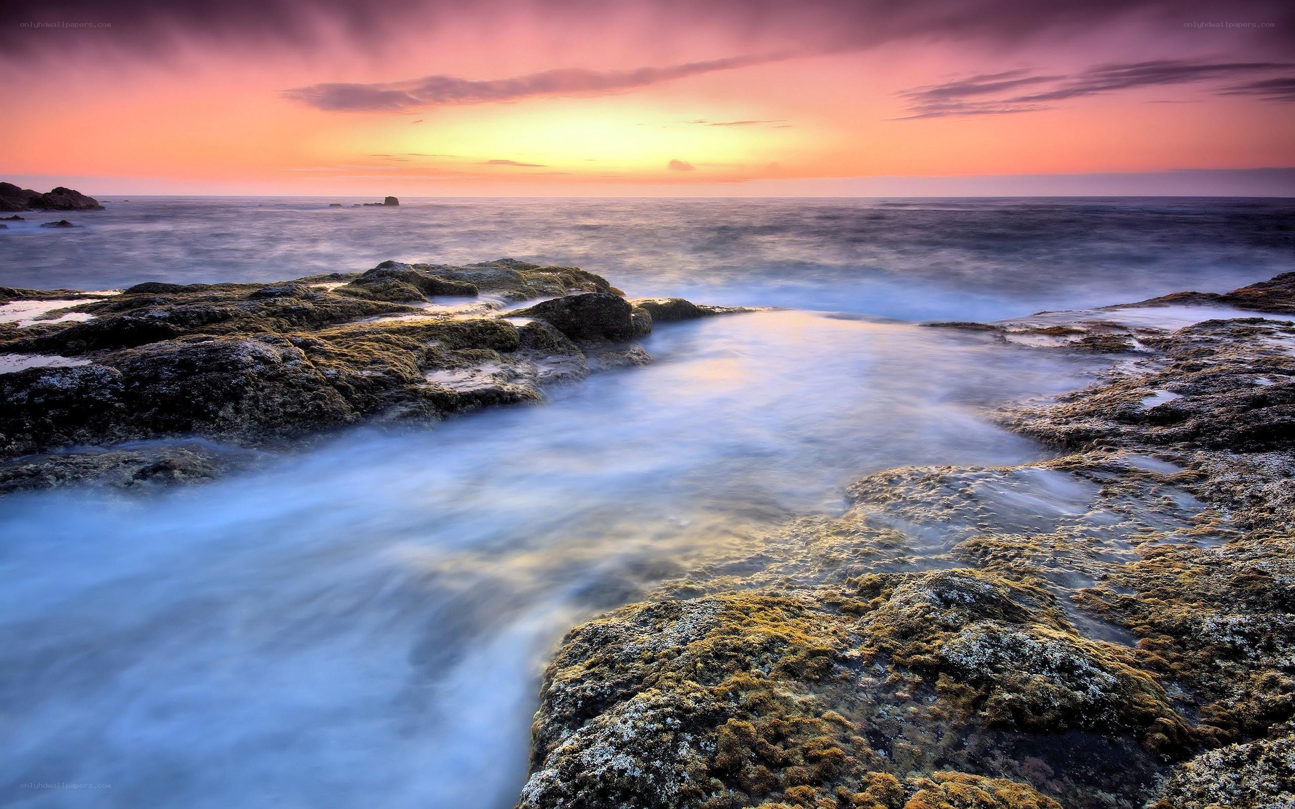 Sunset over rocky coastline