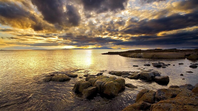sunset over rocky coastline