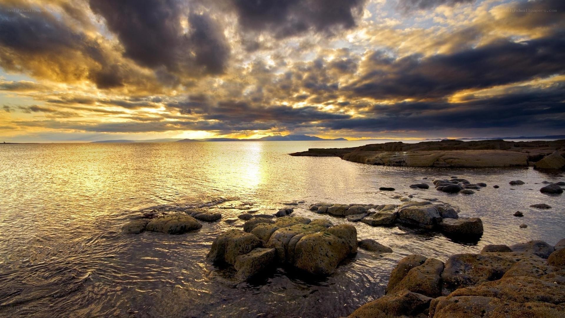 sunset over rocky coastline