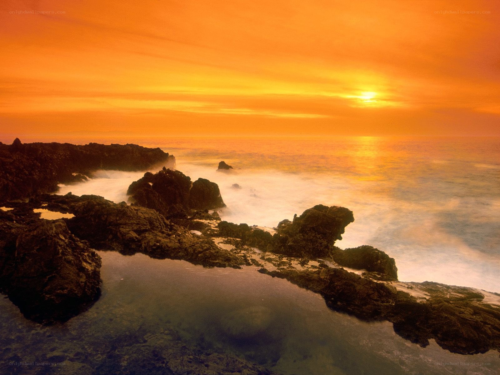 Sunset over rocky coastline