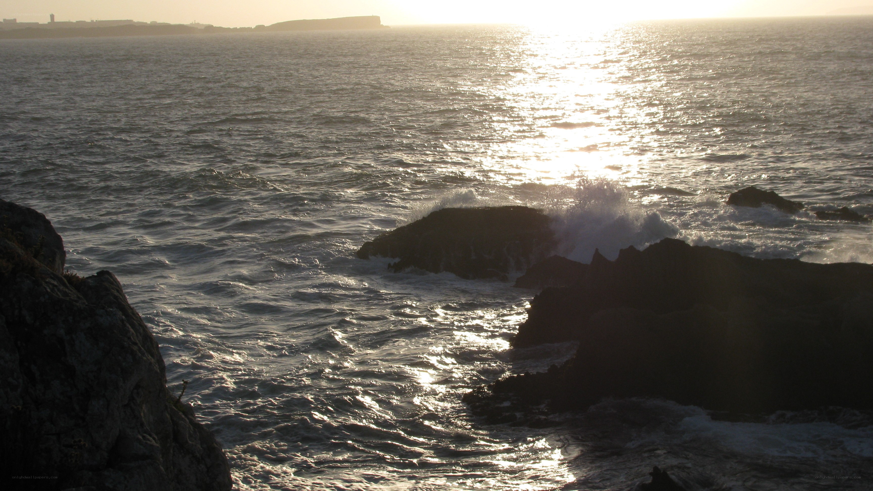 Sunset over rocky coastline