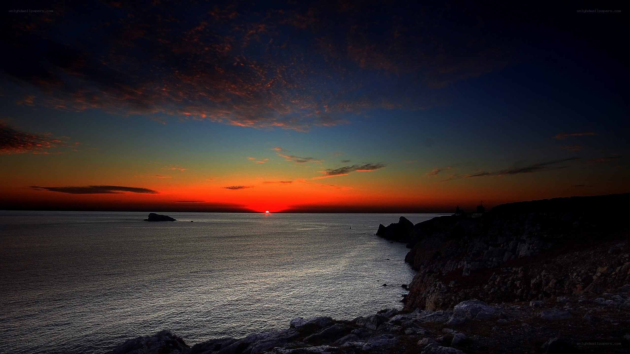 Sunset over rocky coastline