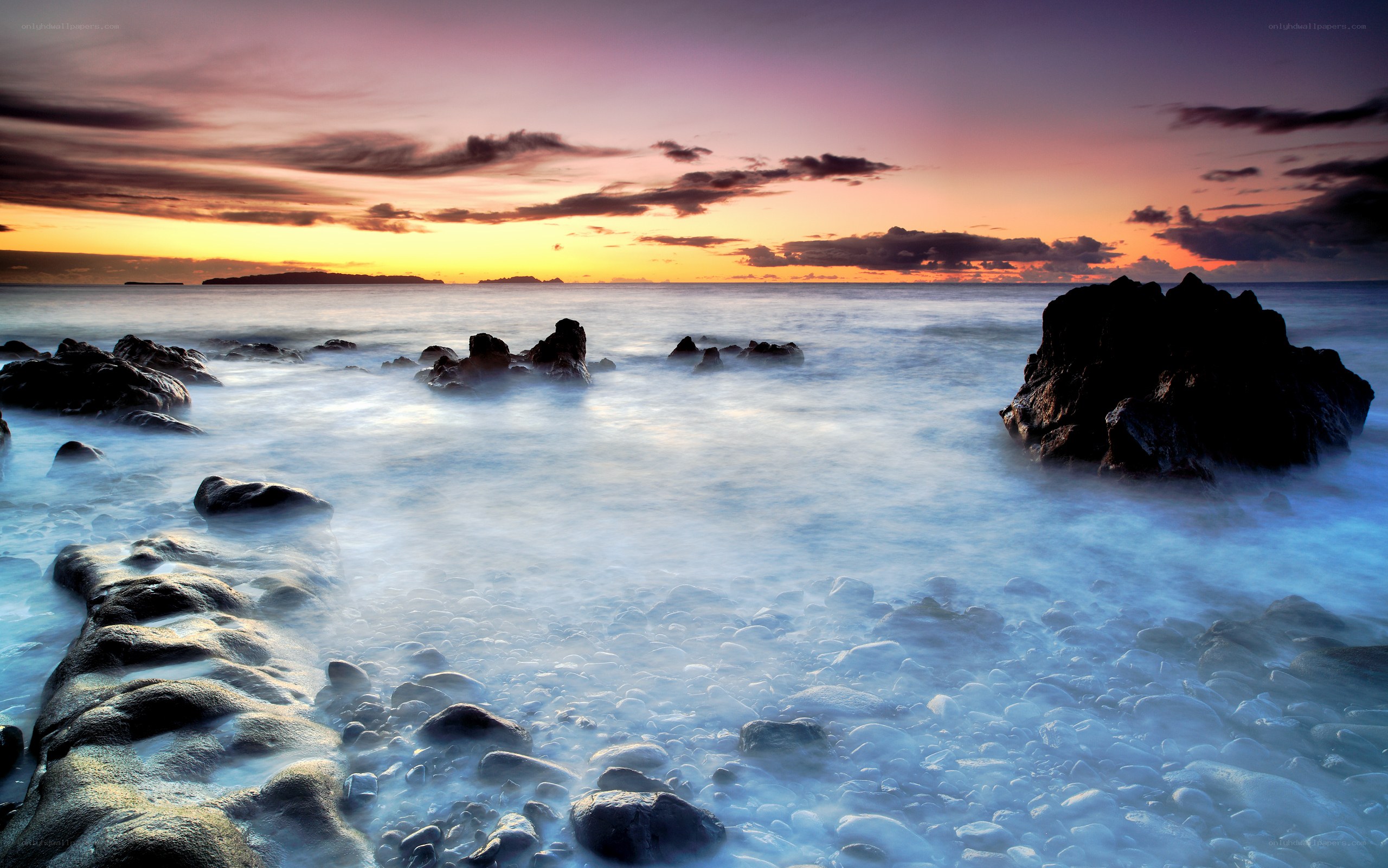 Sunset over rocky coastline