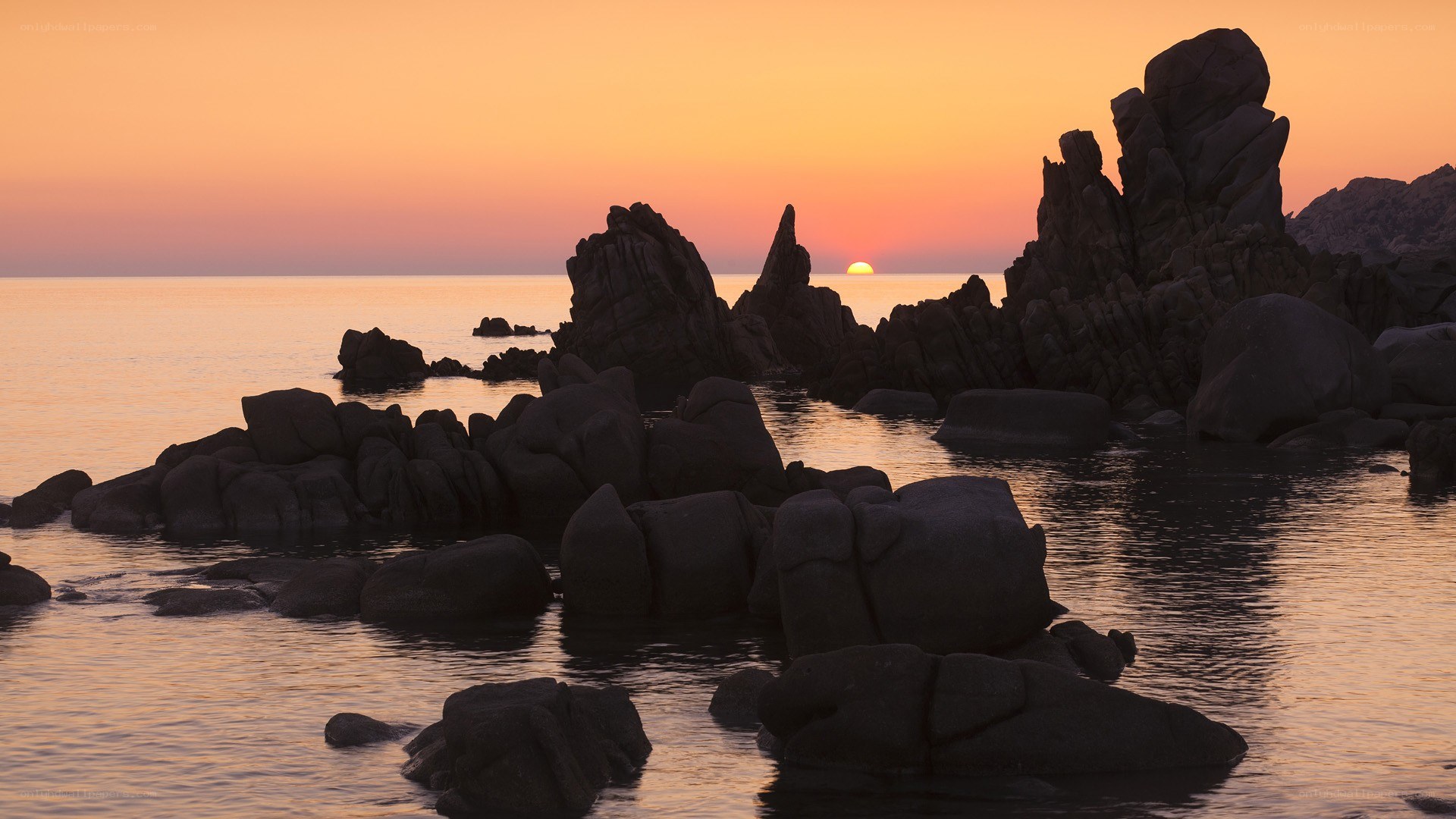 Sunset over rocky coastline