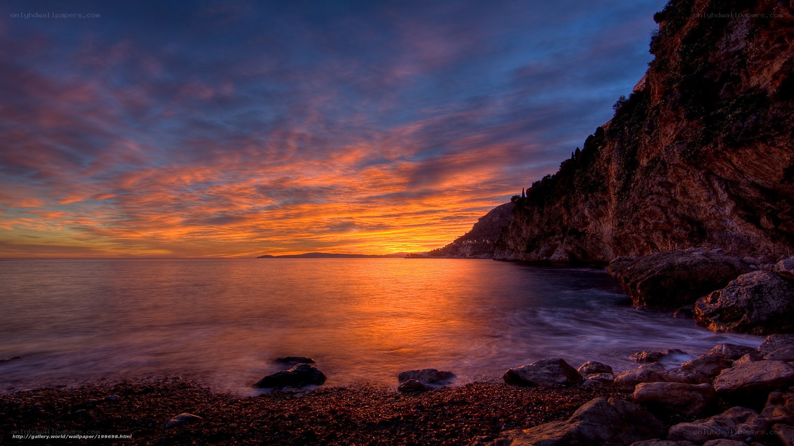 Sunset over rocky coastline