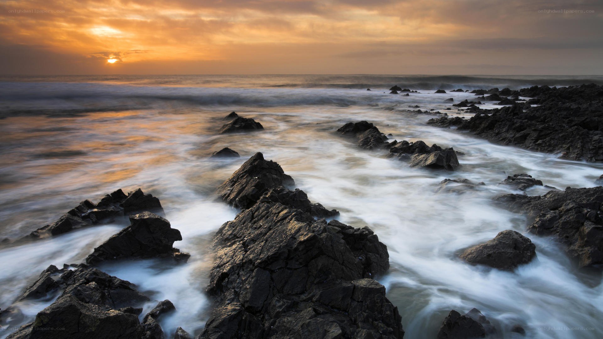 Sunset over rocky coastline