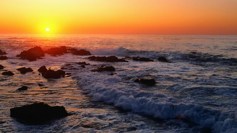 Sunset over rocky coastline