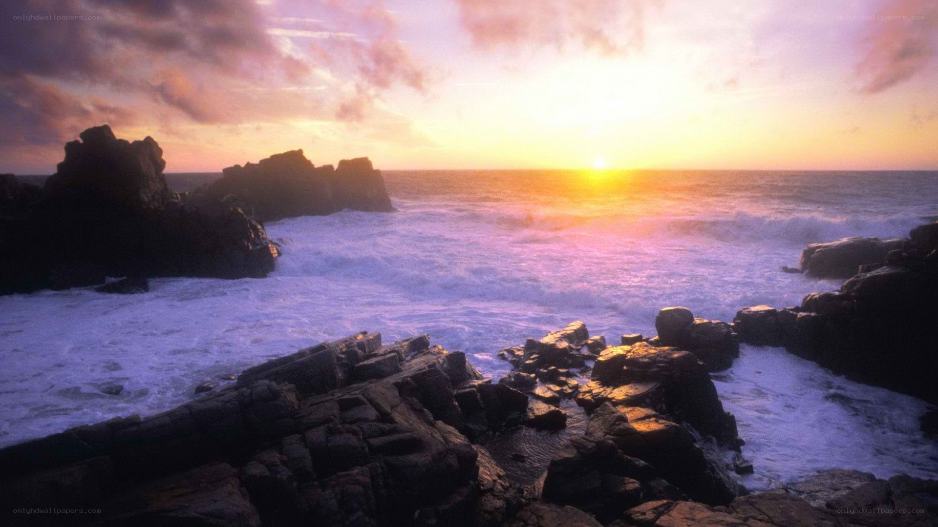 Sunset over rocky coastline