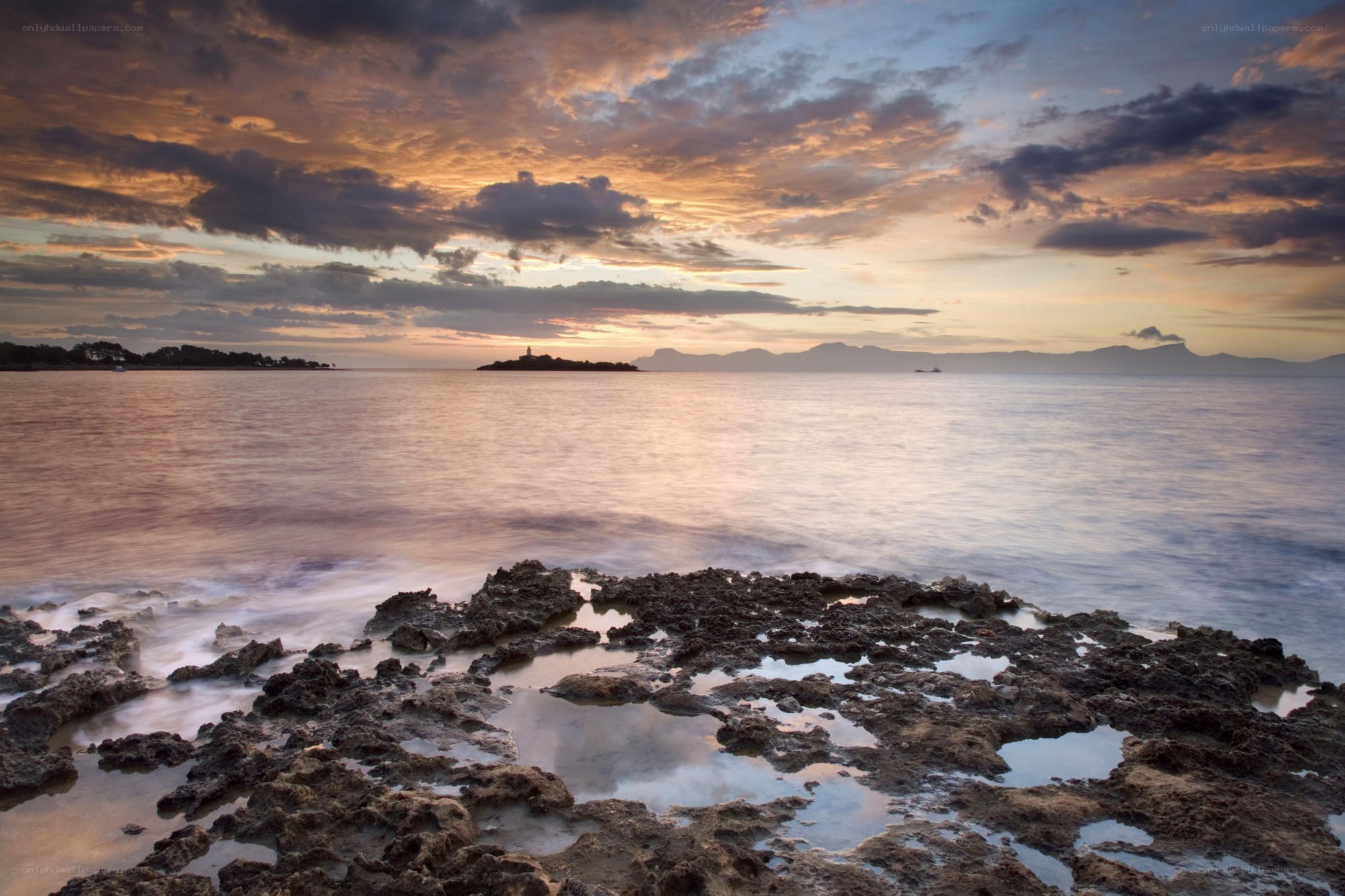 Sunset over rocky coastline