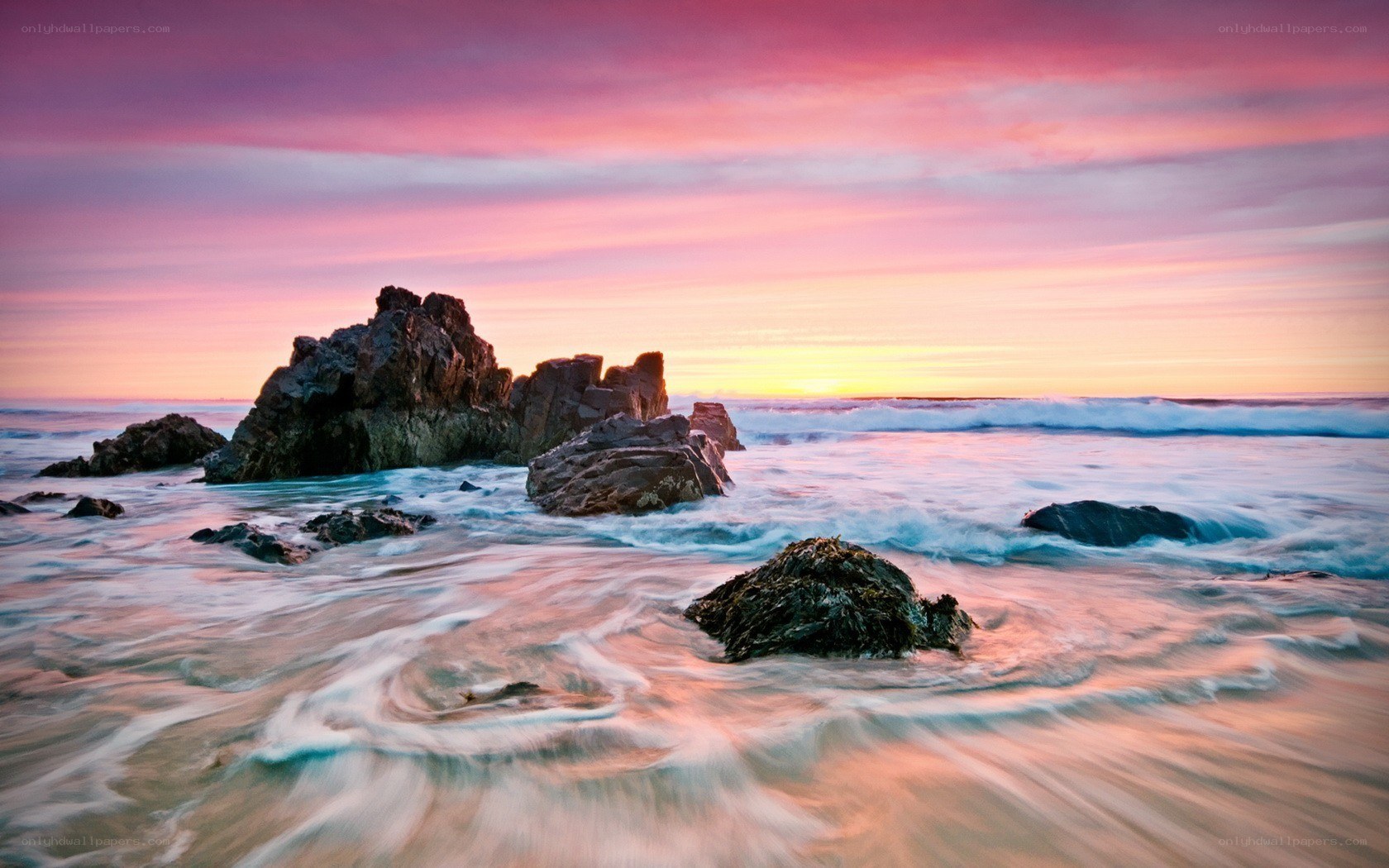 Sunset over rocky coastline