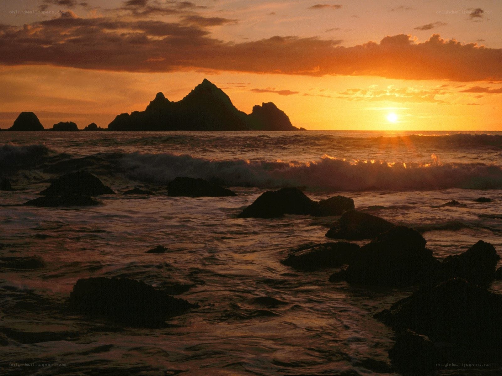 Sunset over rocky coastline