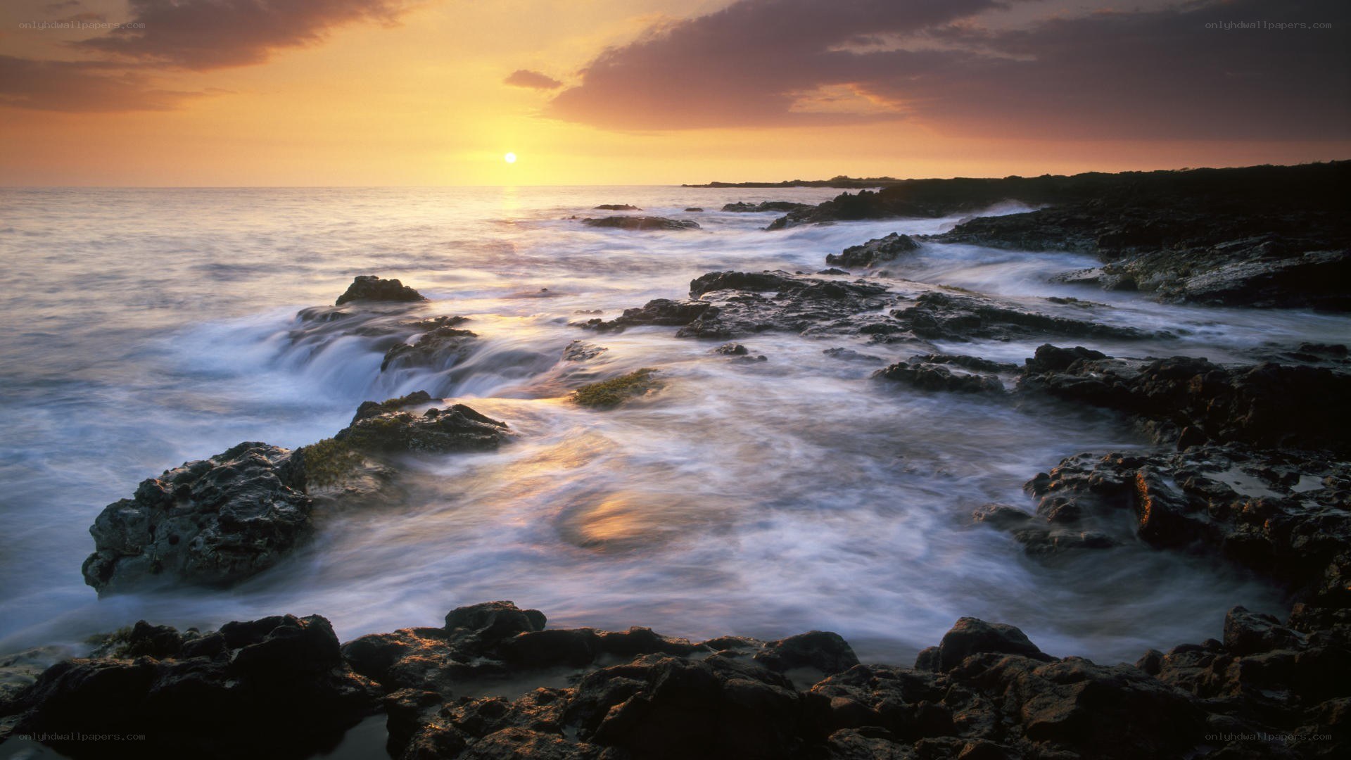 Sunset over rocky coastline
