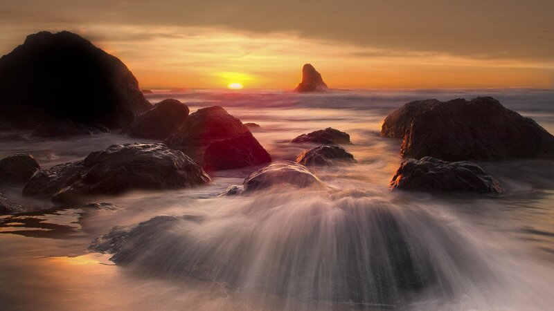 Sunset over rocky coastline
