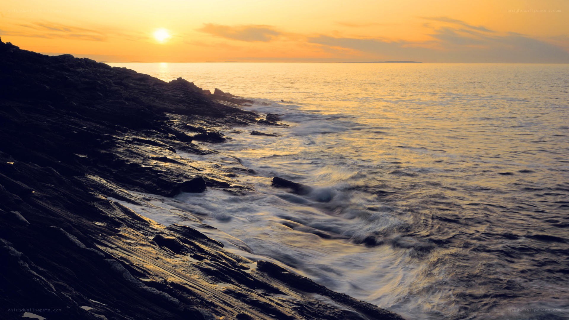 Sunset over rocky coastline