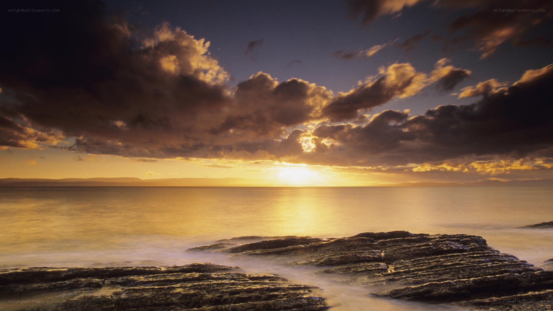 Sunset over rocky coastline