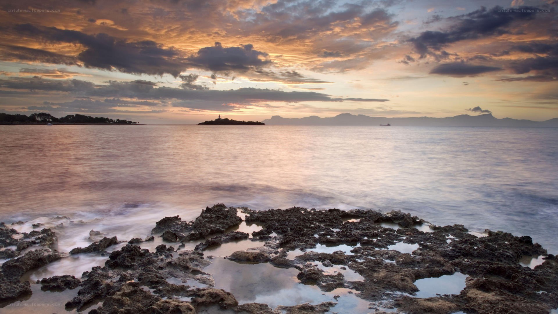 Sunset over rocky coastline