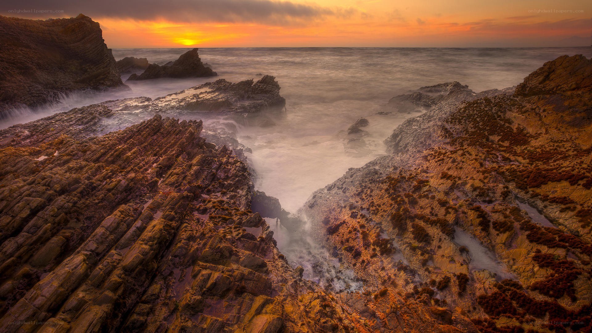 Sunset over rocky coastline