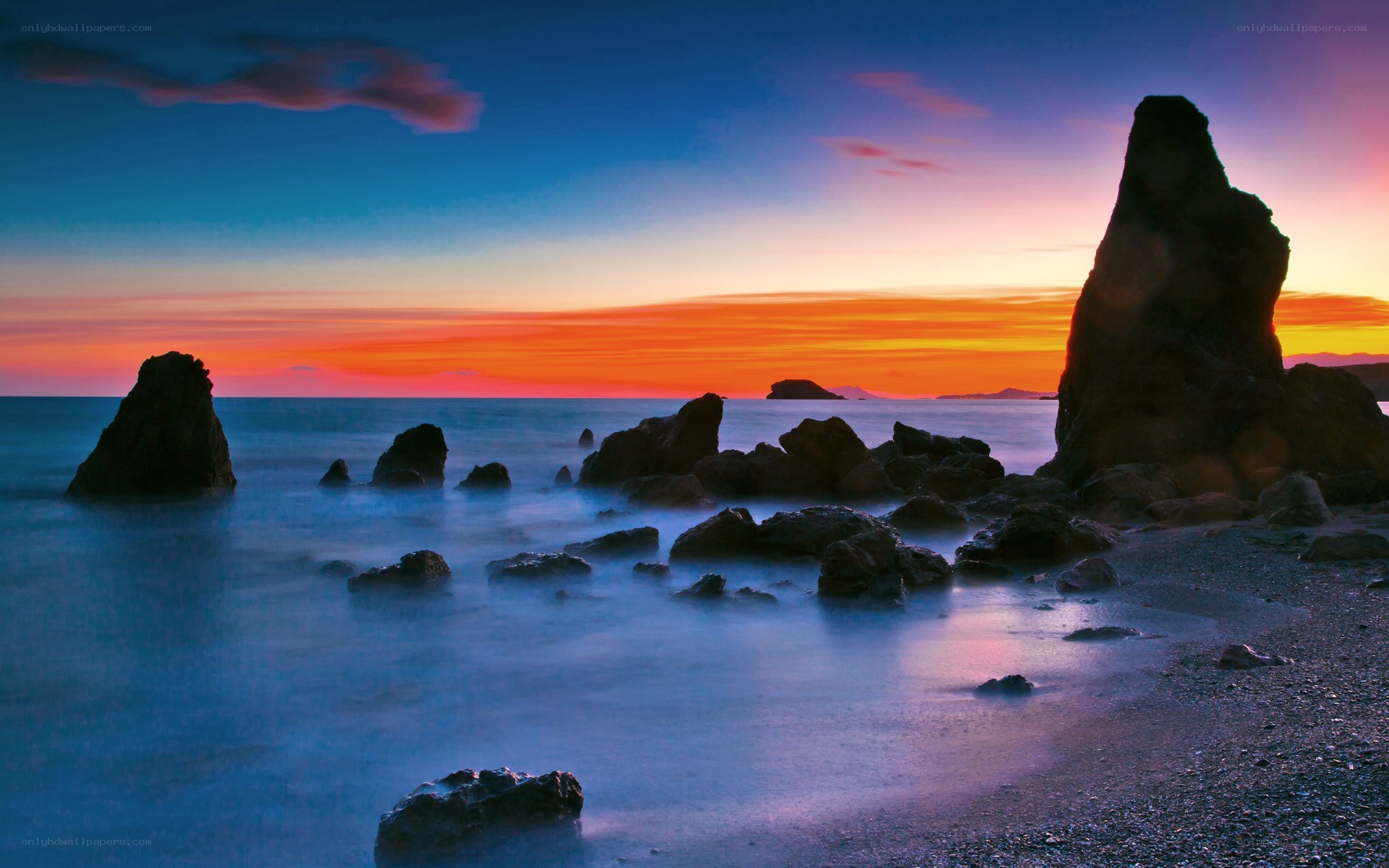 Sunset over rocky coastline