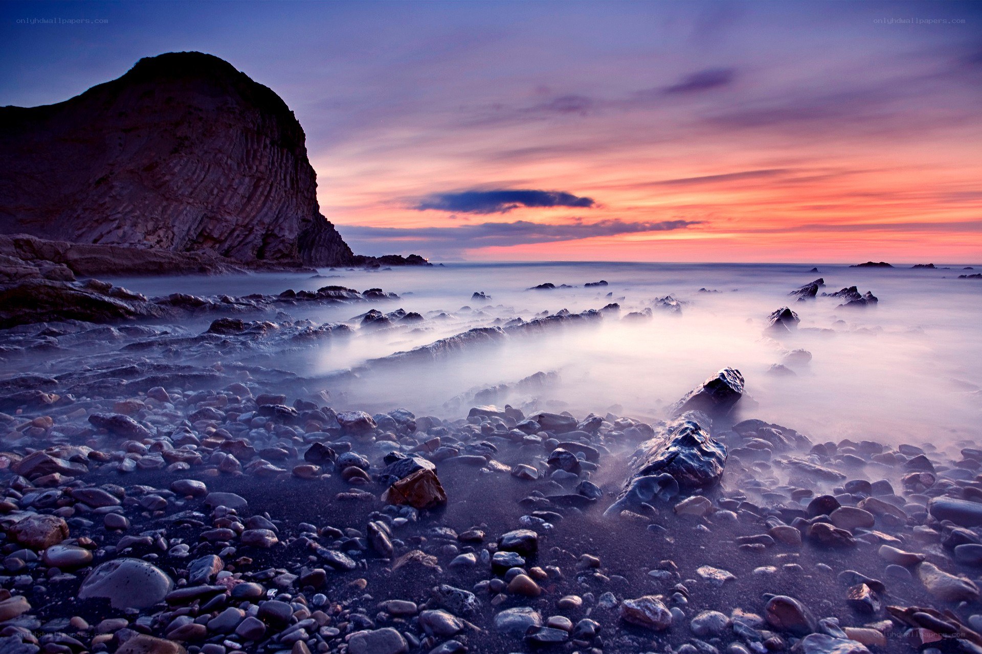 Sunset over rocky coastline