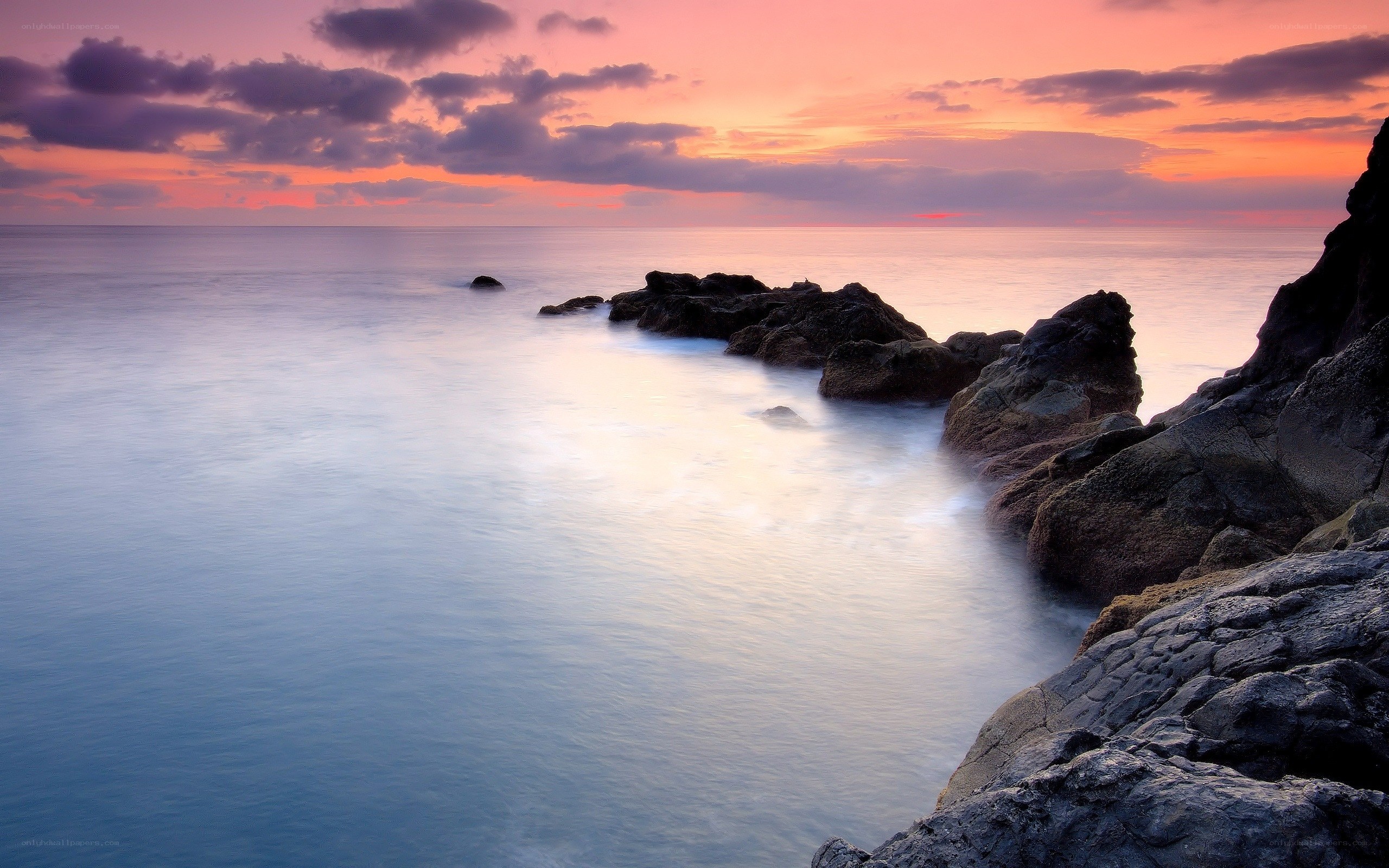 Sunset over rocky coastline