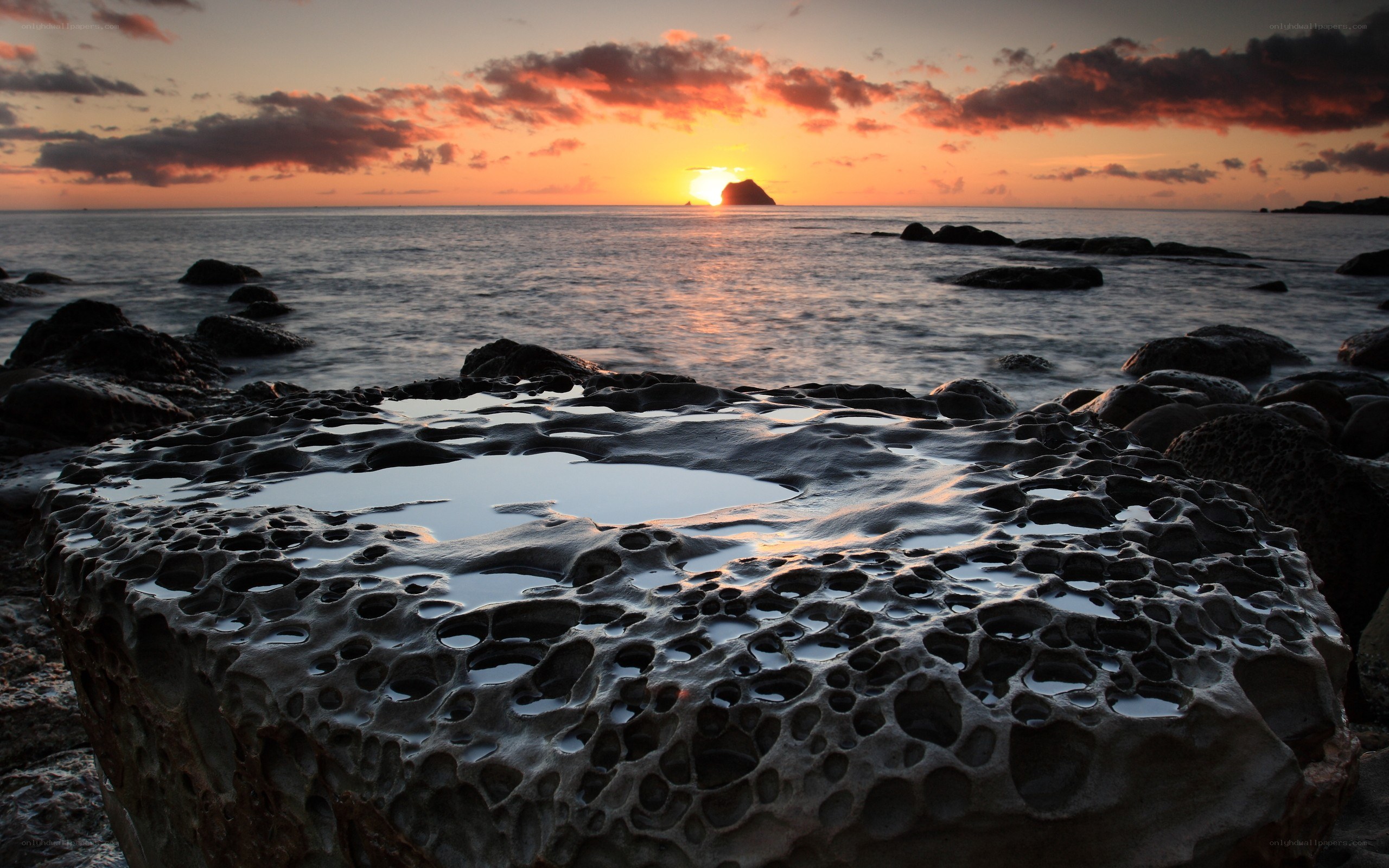 Sunset over rocky coastline