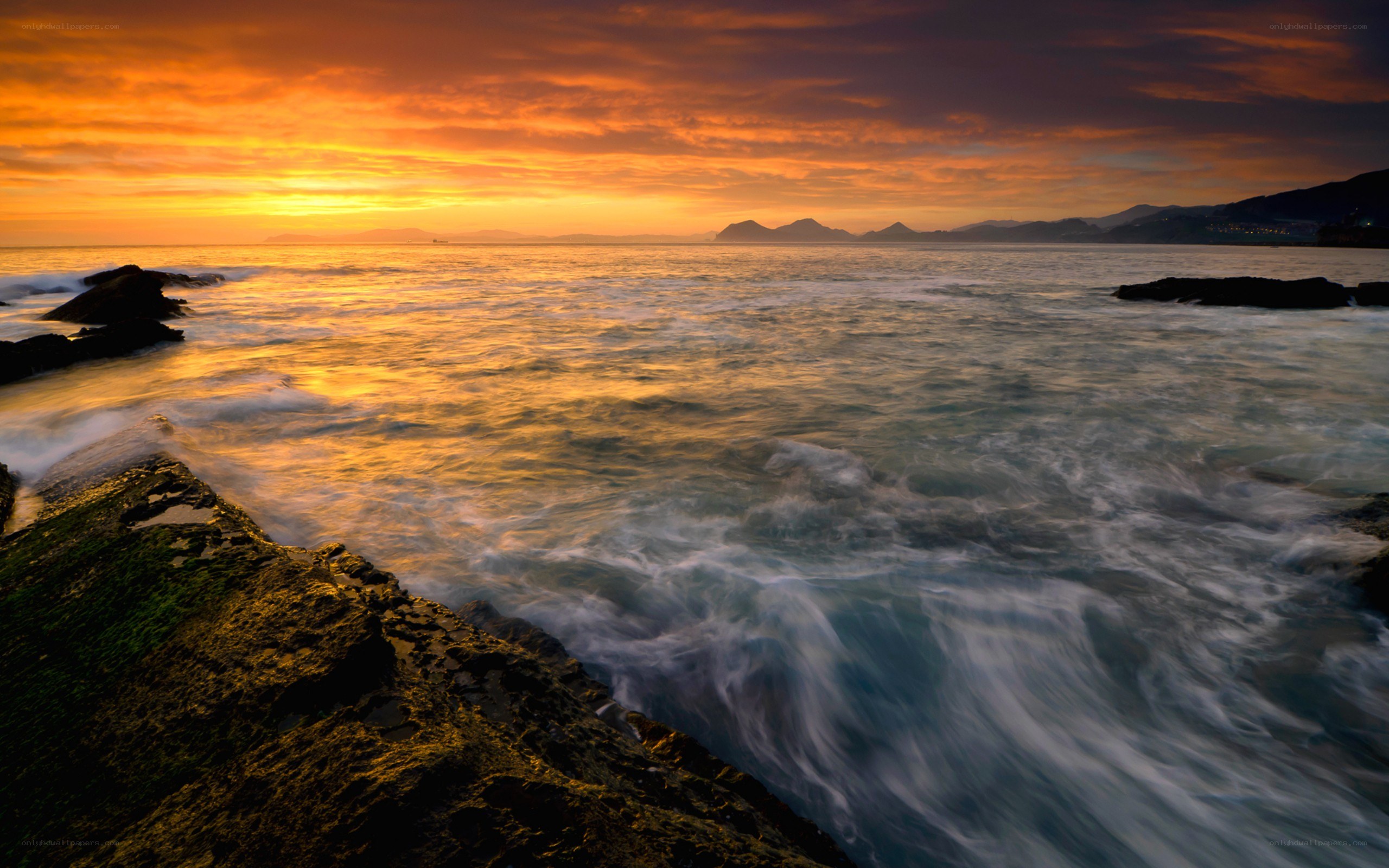 Sunset over rocky coastline