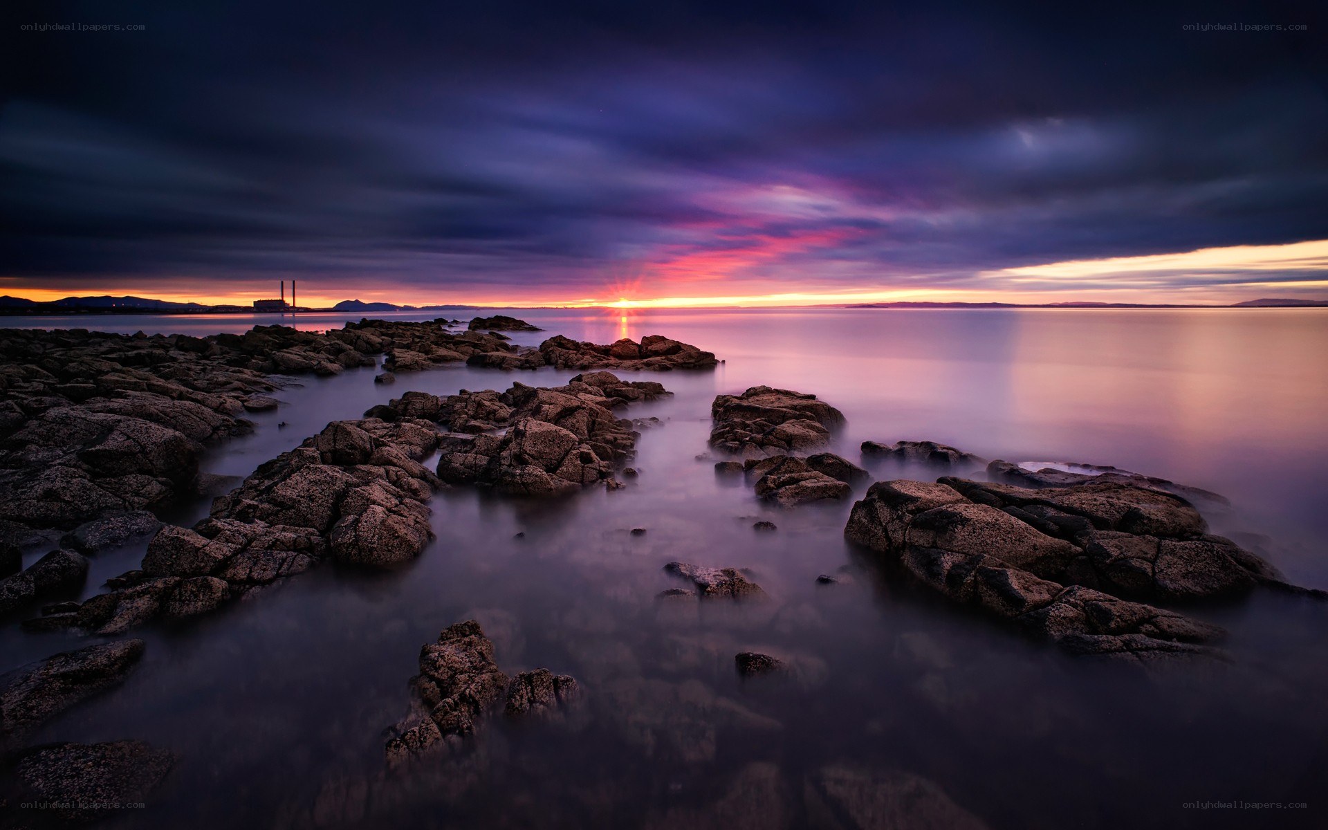 Sunset over rocky coastline