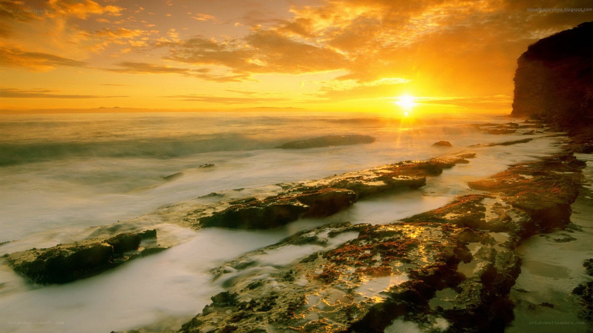 Sunset over rocky coastline