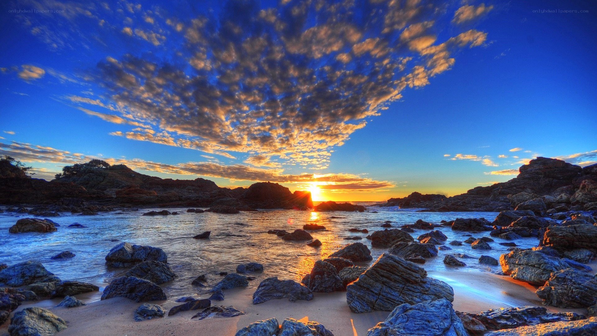 Sunset over rocky coastline