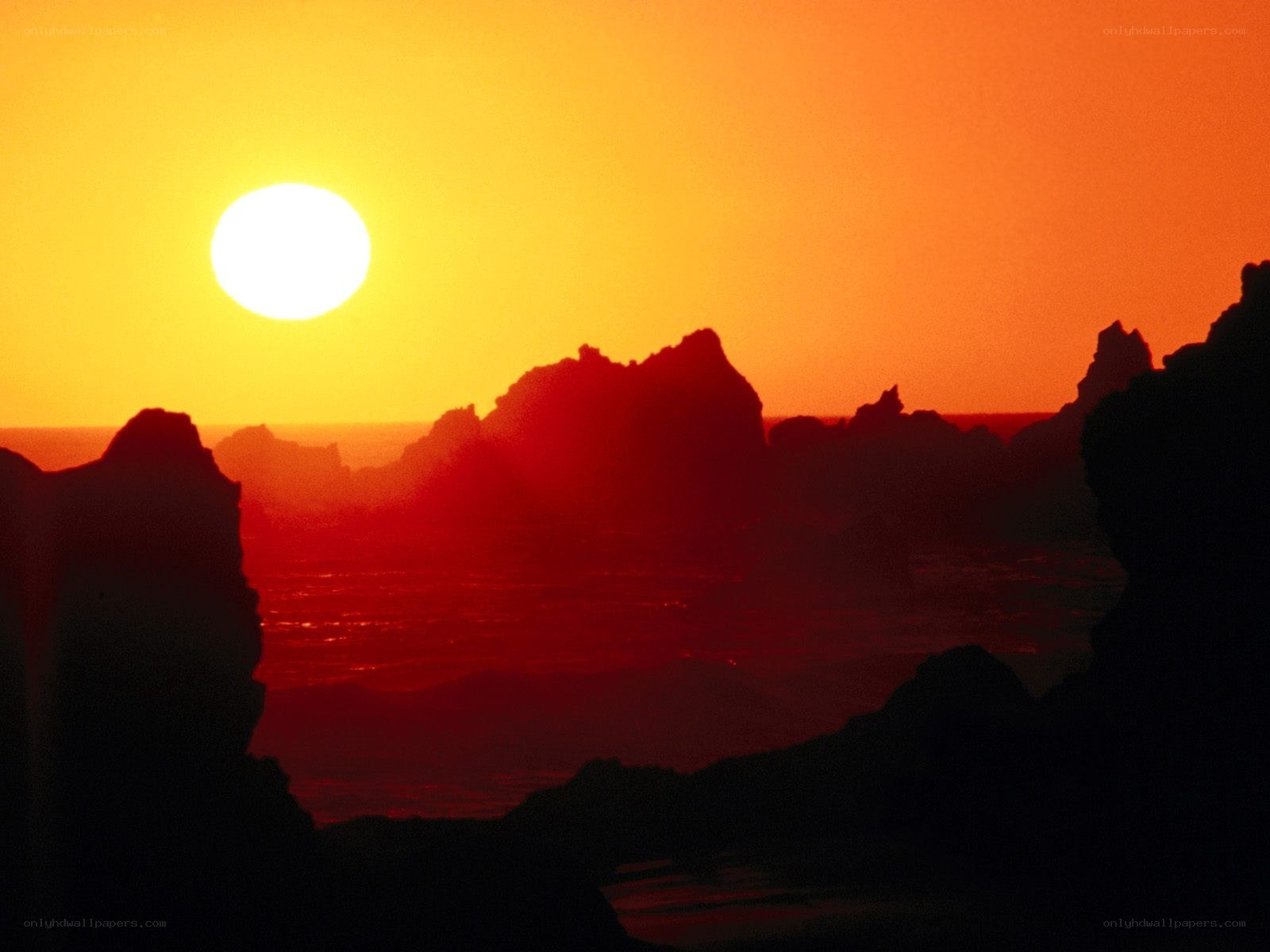 Sunset over rocky coastline