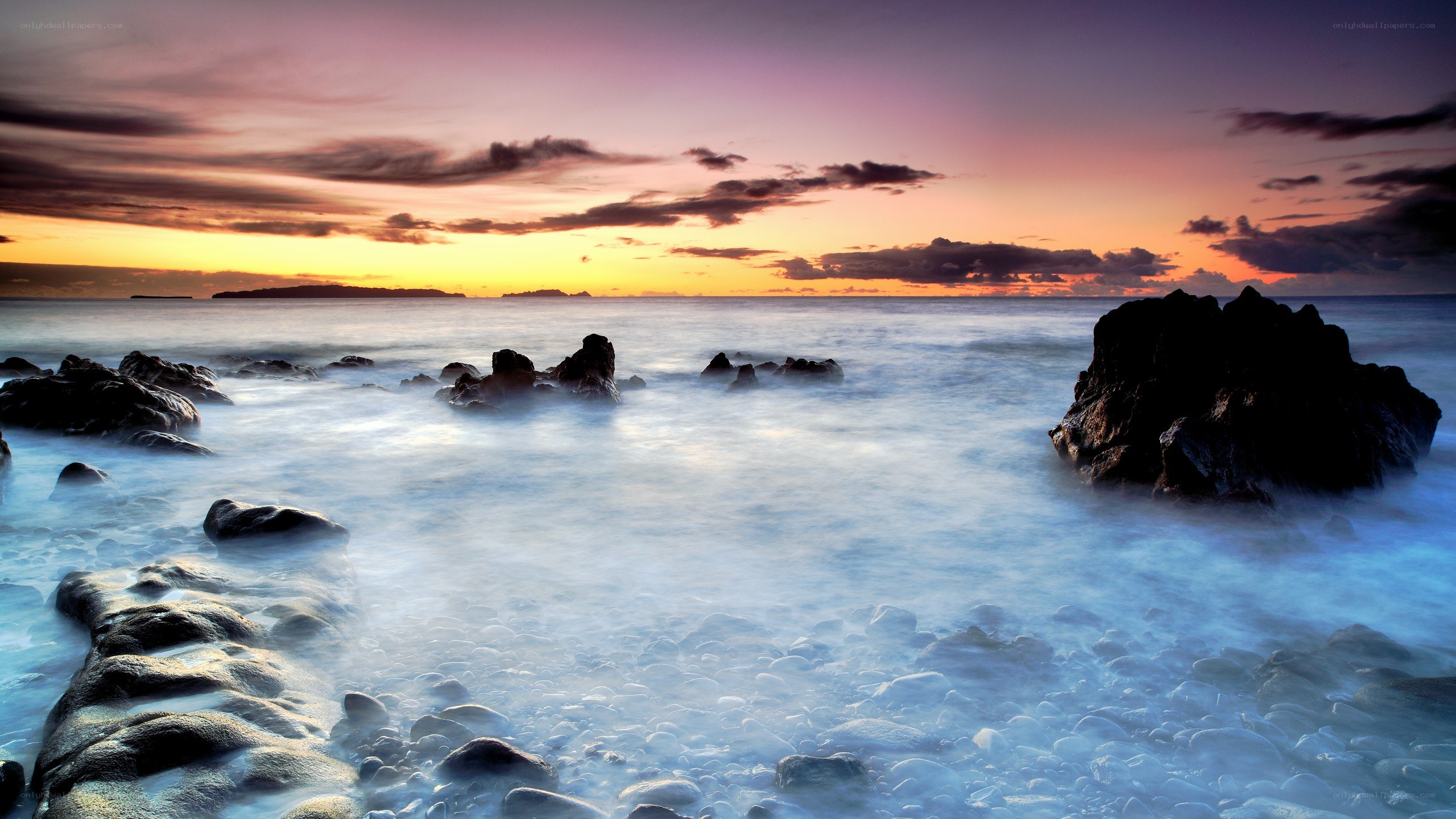Sunset over rocky coastline