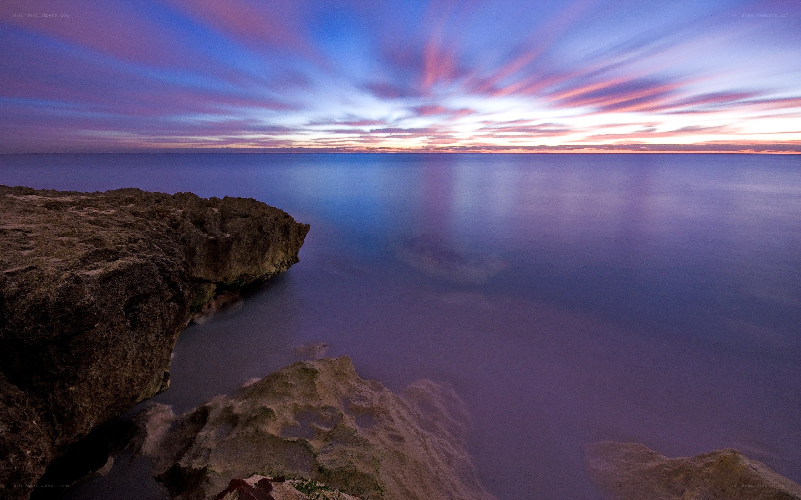 Sunset over rocky coastline
