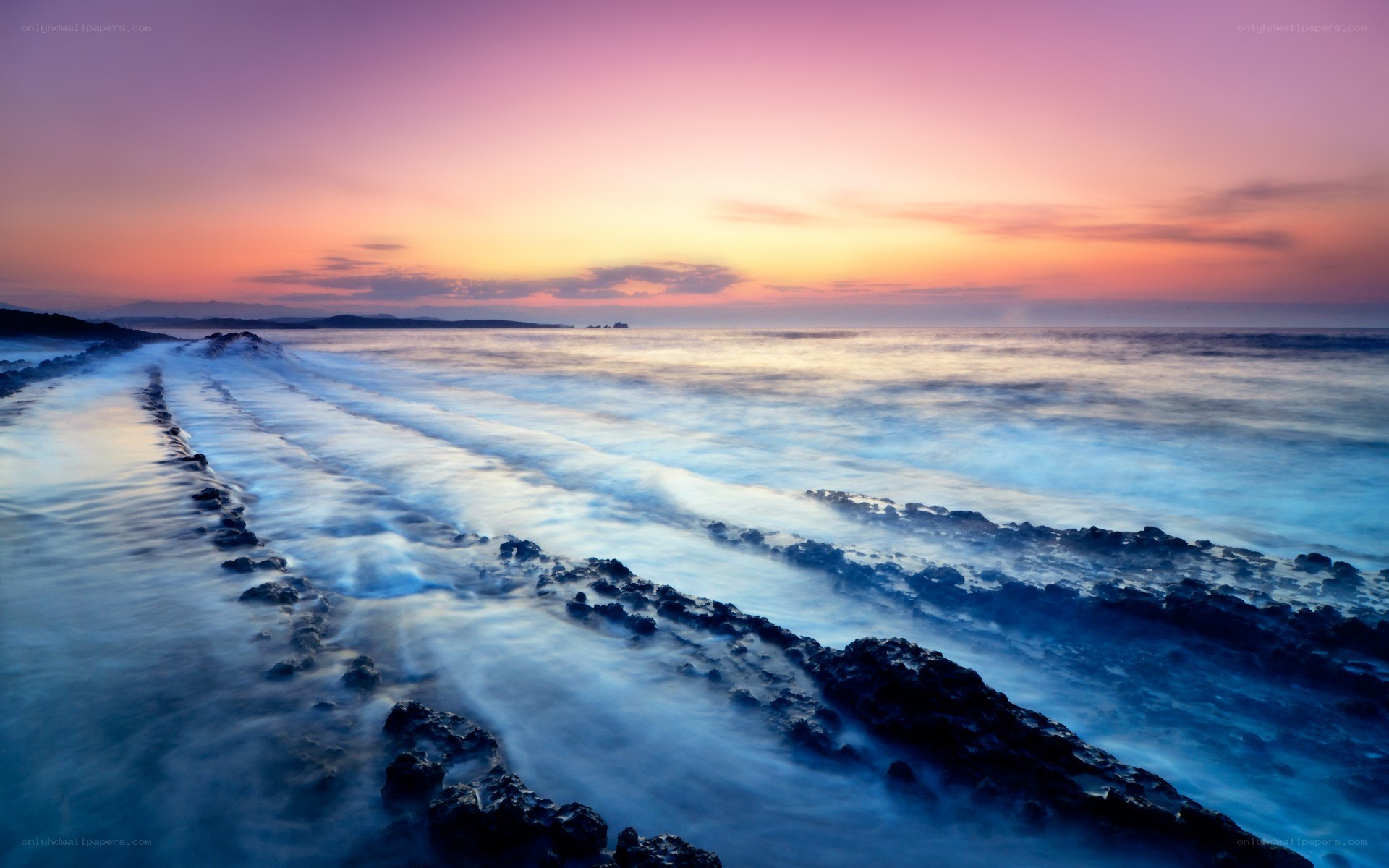 Sunset over rocky coastline