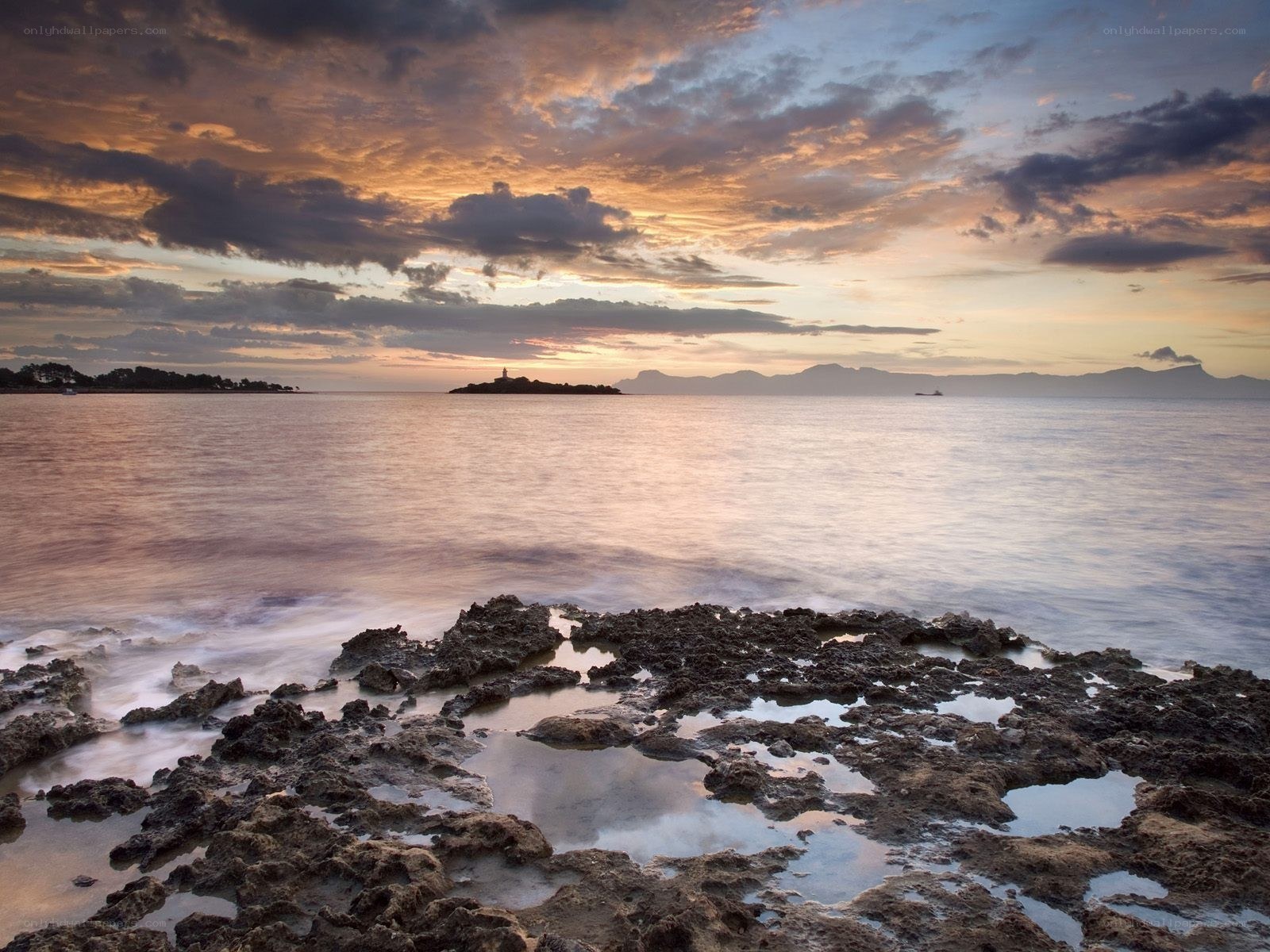 Sunset over rocky coastline