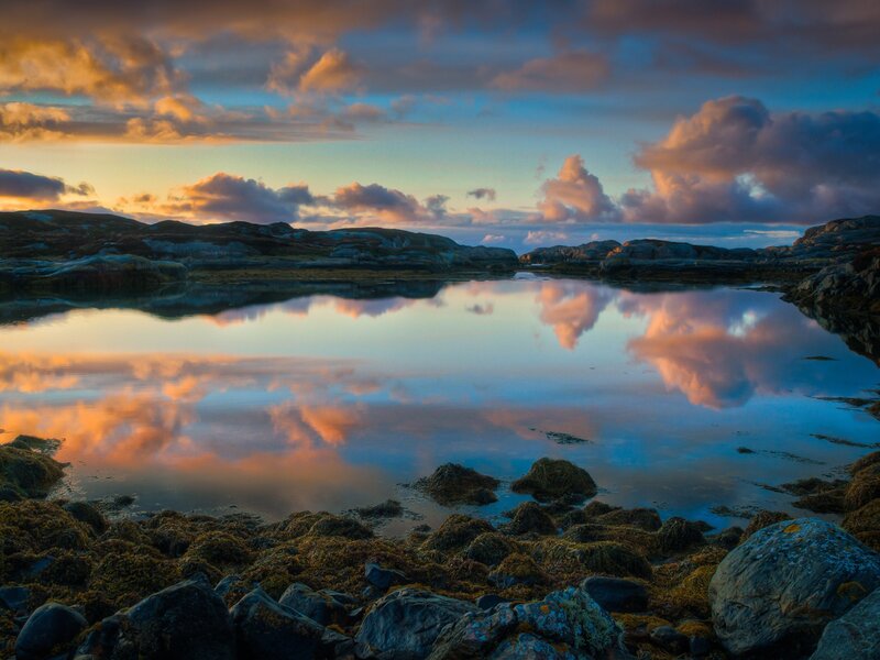 Sunset over rocky coastline