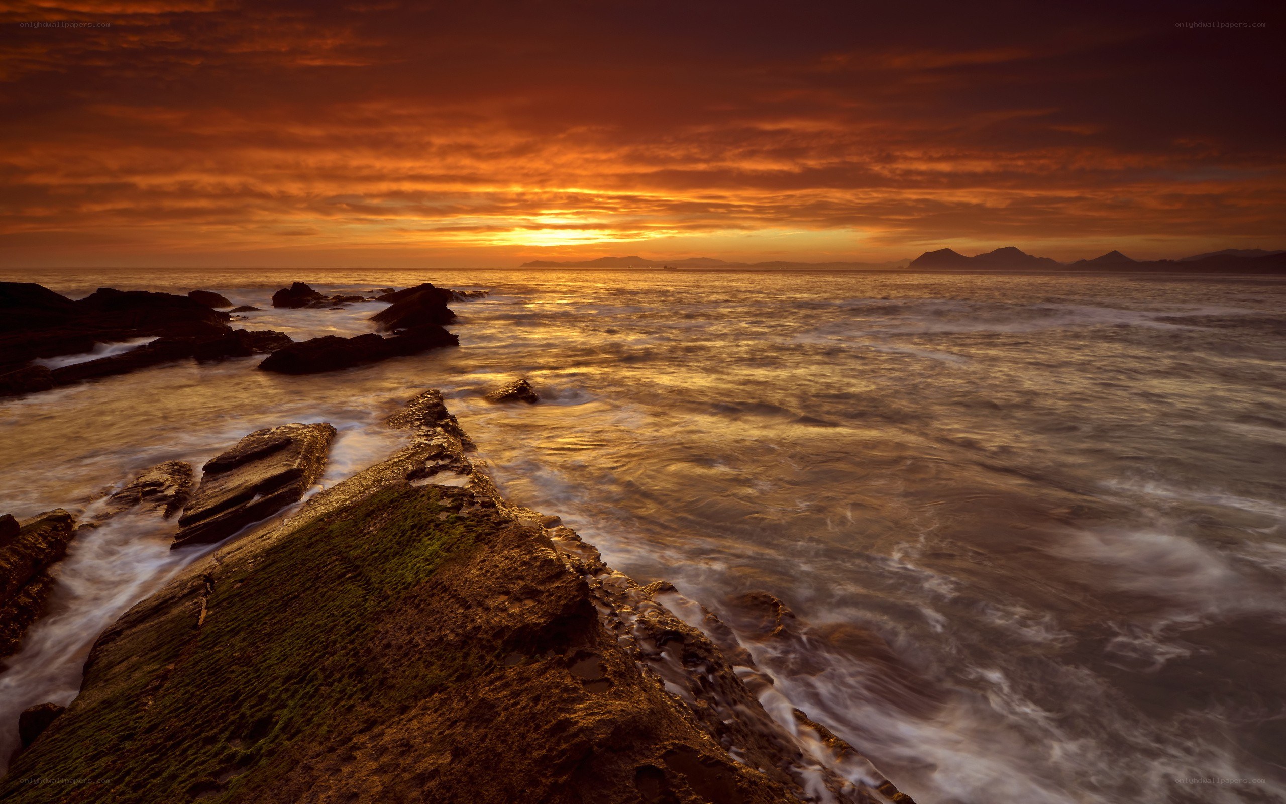 Sunset over rocky coastline