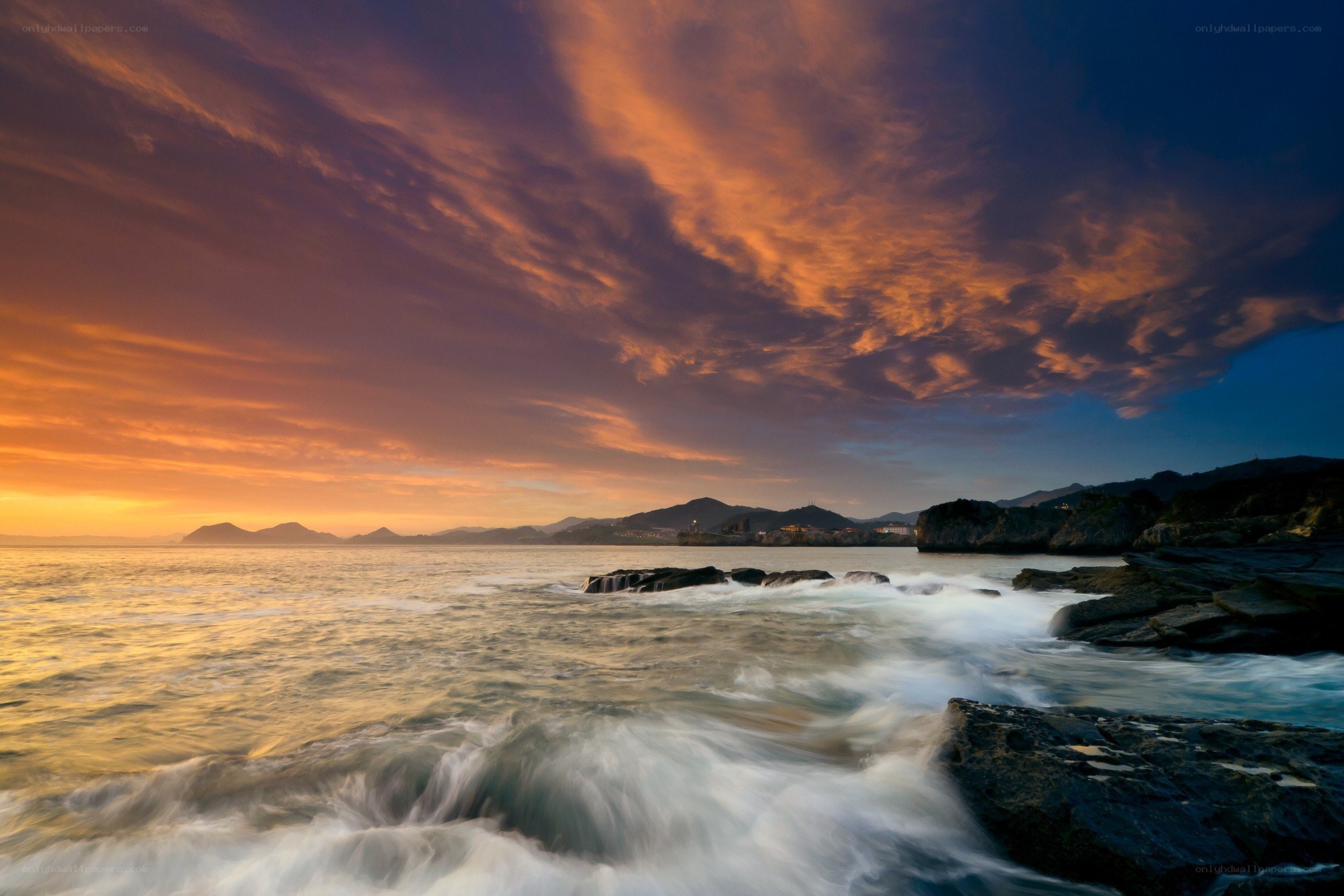 Sunset over rocky coastline