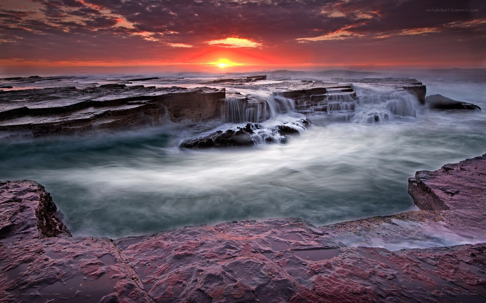 Sunset over rocky coastline