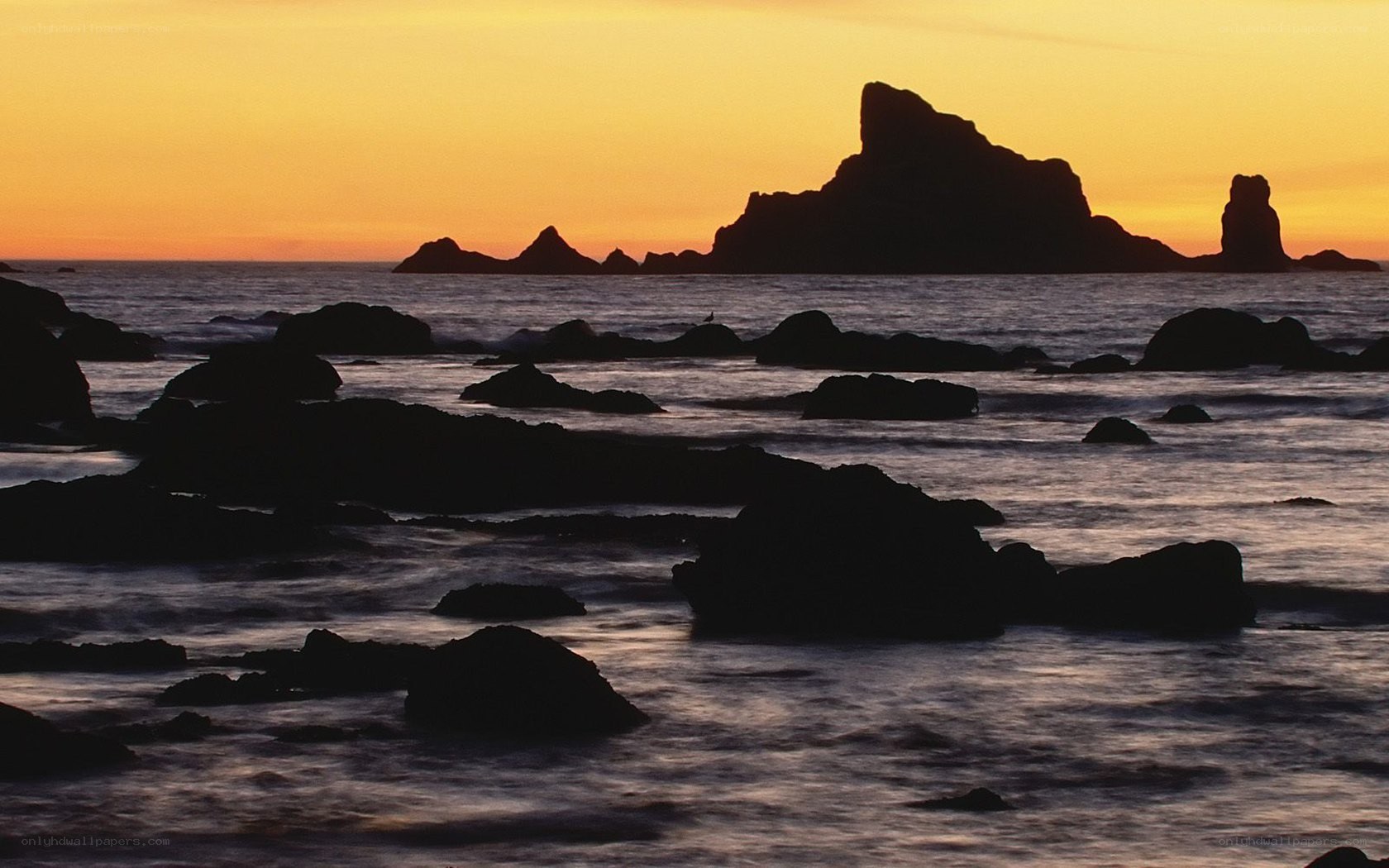 Sunset over rocky coastline