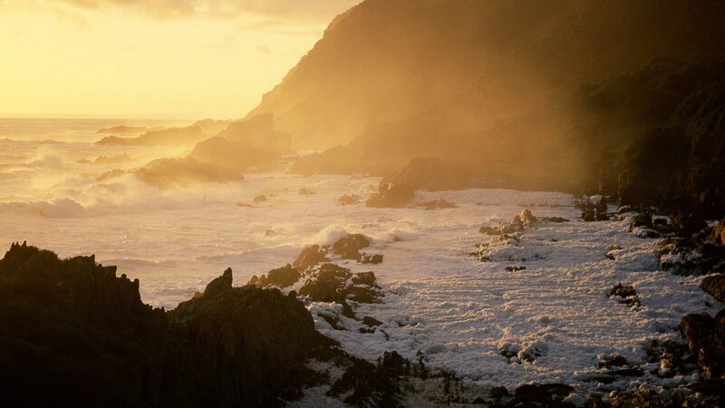 Sunset over rocky coastline
