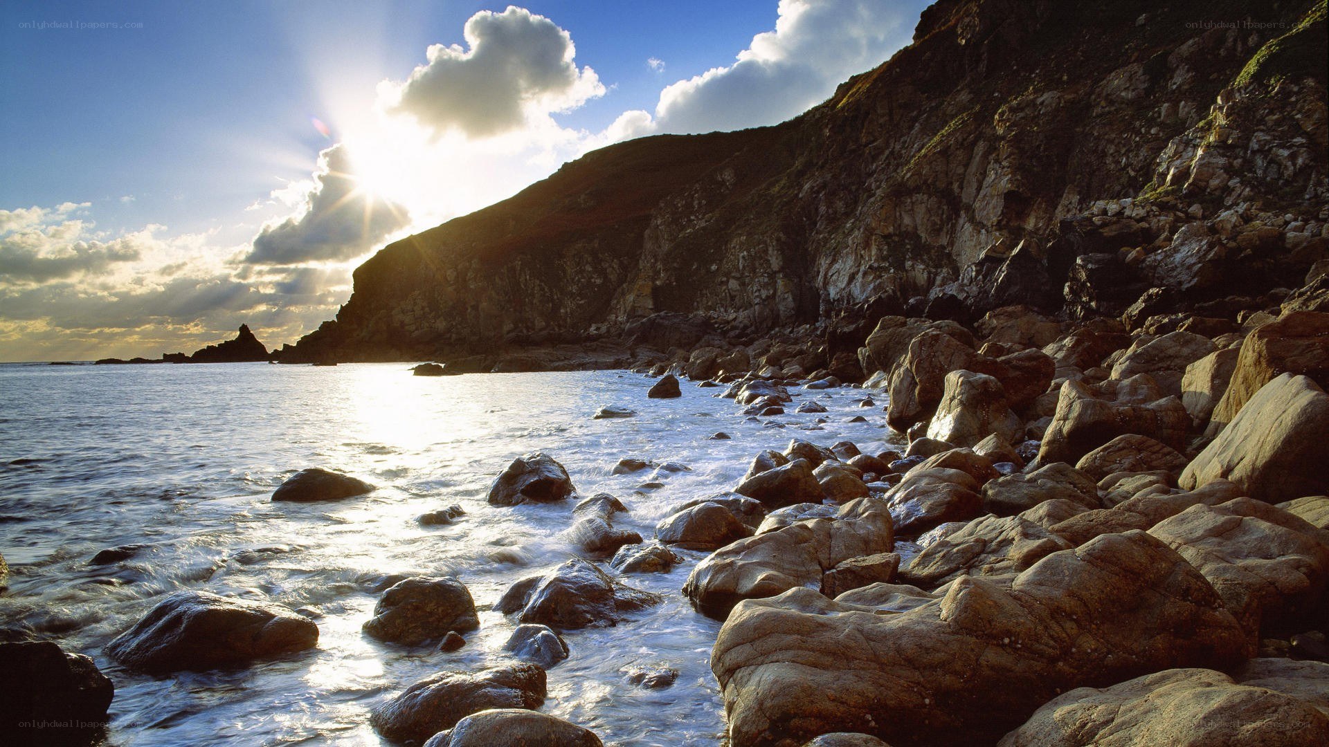 Sunset over rocky coastline