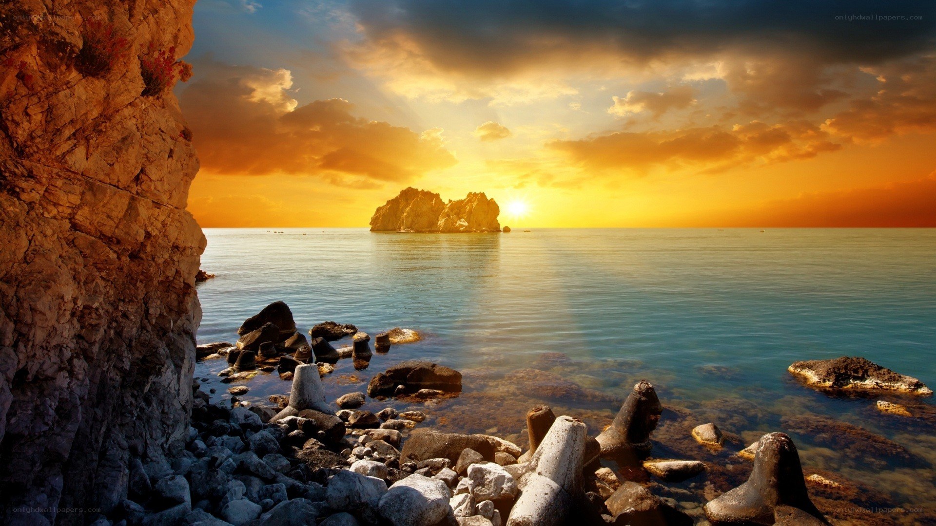 Sunset over rocky coastline