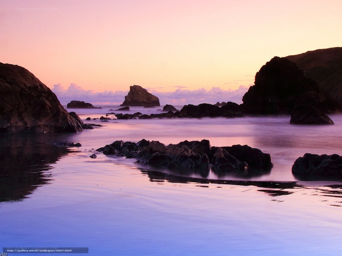 Sunset over rocky coastline