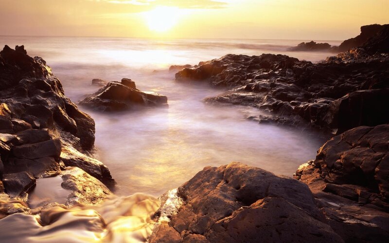 Sunset over rocky coastline