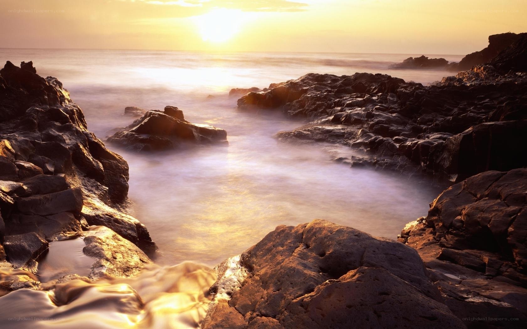 Sunset over rocky coastline