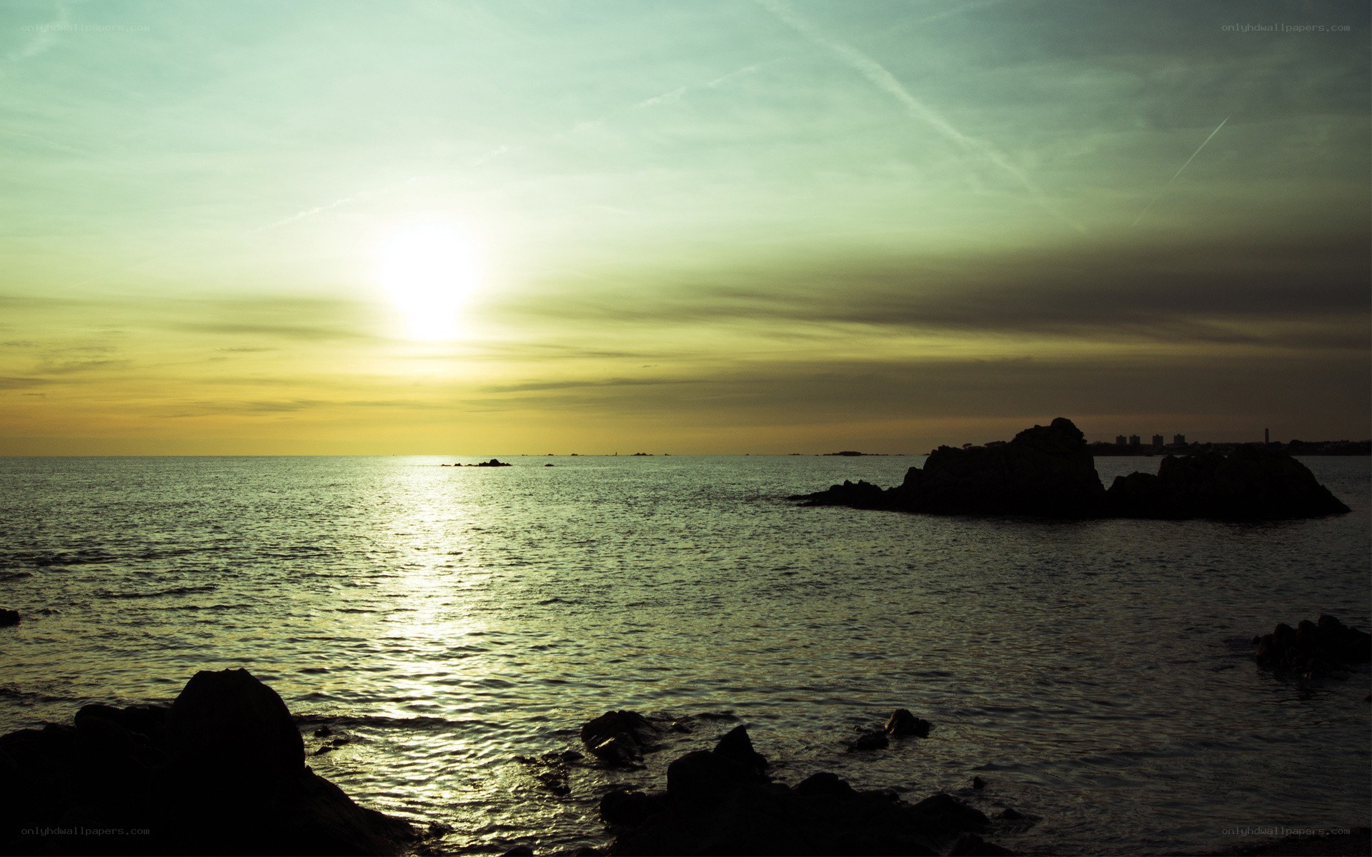 sunset over rocky coastline